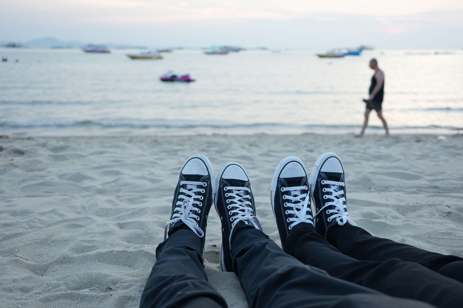 Couple relaxing on Pattaya beach at sunset