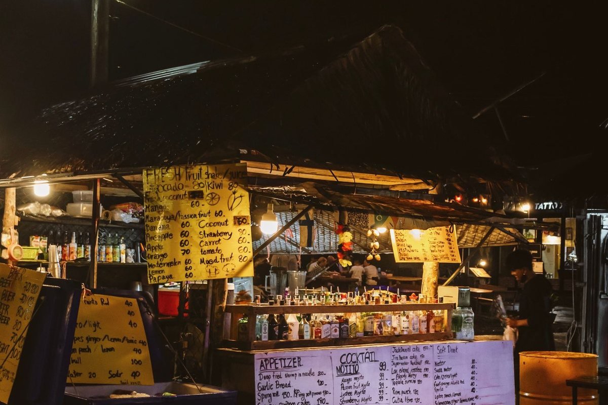 A lit night market food stall in Thailand